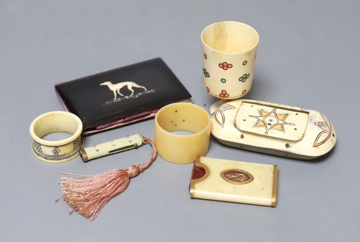 A George III ivory needle case, 6cm. a Victorian card purse inlaid with a whippet, 9.5cm, a horn snuff box and four other items.